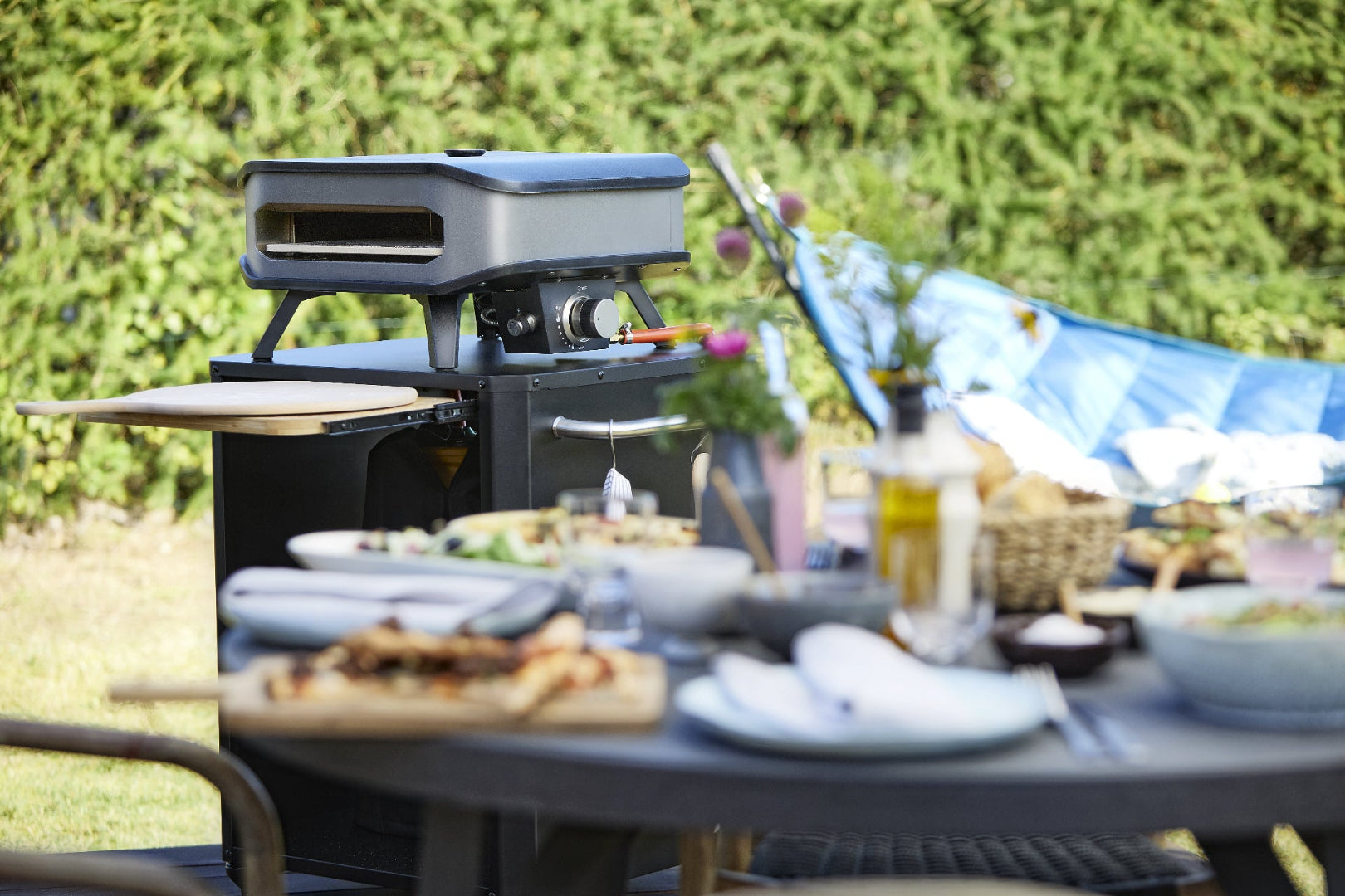 Lifestyle image of grill and accessories, inviting outdoor entertaining scene.