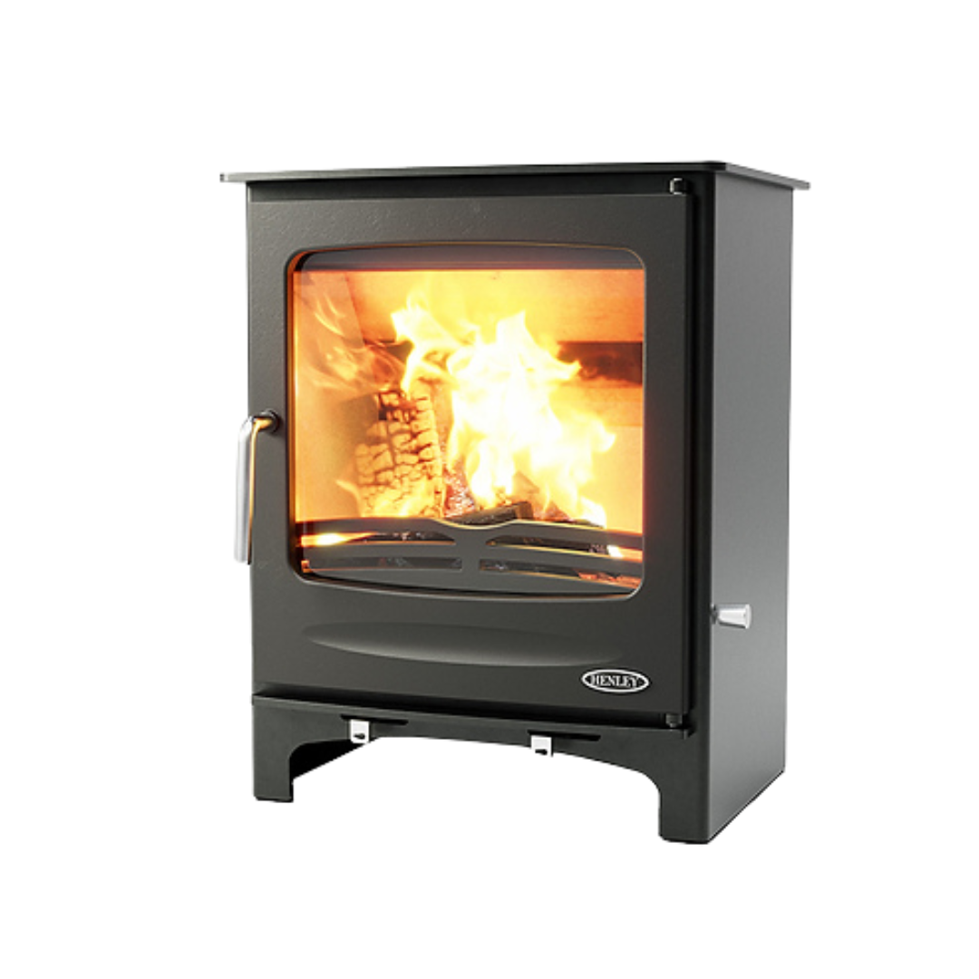 A freestanding, modern black fireplace with a visible fire through the glass door.