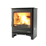 A freestanding, modern black fireplace with a visible fire through the glass door.