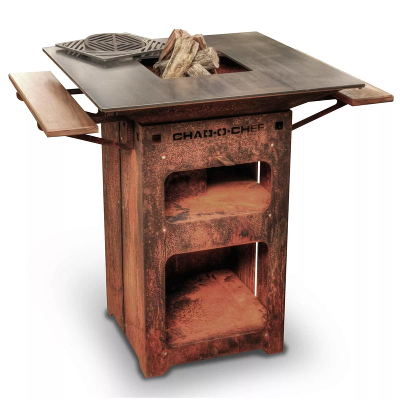 Rustic corten-steel outdoor braai grill with a square flat-top cooking surface, central fire pit, side shelves, and storage compartments.”