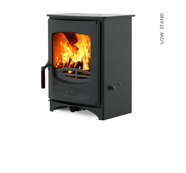 A black Charnwood C-Four wood burning stove with a visible fire through the glass door, featuring a heat resistant wooden handle and ashpan.
