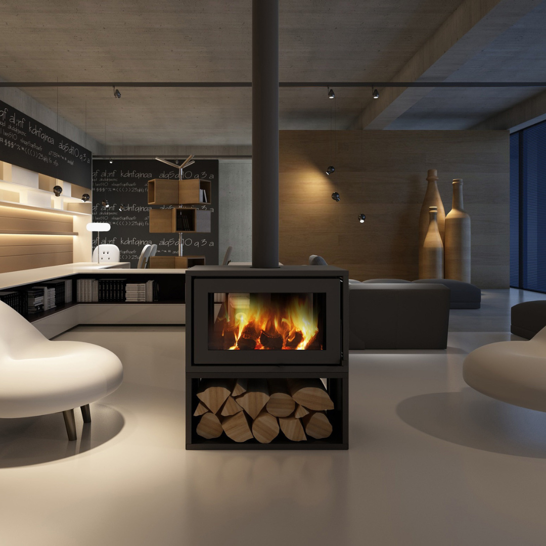 Modern freestanding wood stove with a visible firebox and log holder, placed in a contemporary room with concrete walls and white furniture.