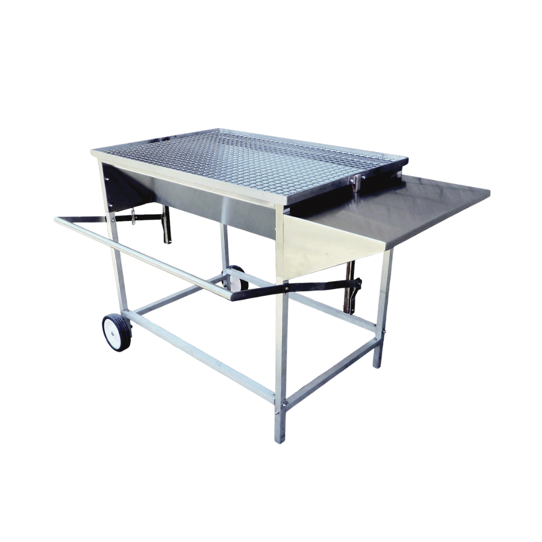 A large, adjustable stainless steel charcoal drum braai with aluminum legs, a side shelf, and wheels for mobility.