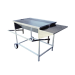 A large, adjustable stainless steel charcoal drum braai with aluminum legs, a side shelf, and wheels for mobility.