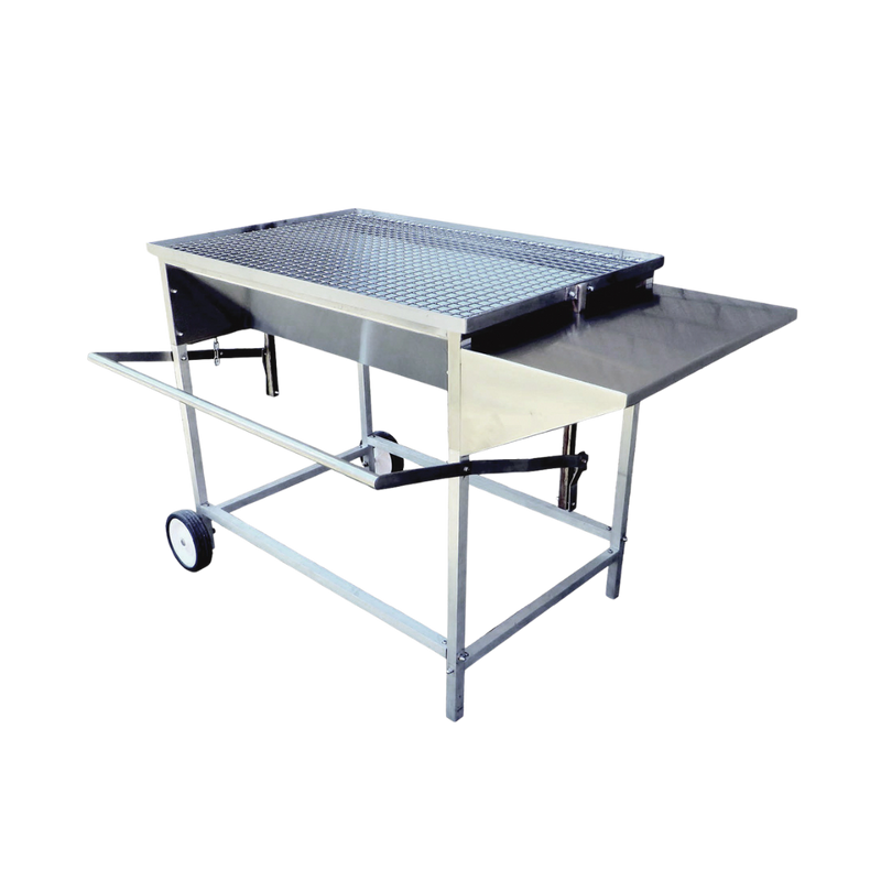 A large, adjustable stainless steel charcoal drum braai with aluminum legs, a side shelf, and wheels for mobility.