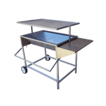 A large, adjustable stainless steel charcoal drum braai with aluminum legs, a side shelf, and wheels for mobility.