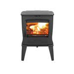 A freestanding black wood-burning fireplace with visible flames and a heat shield.