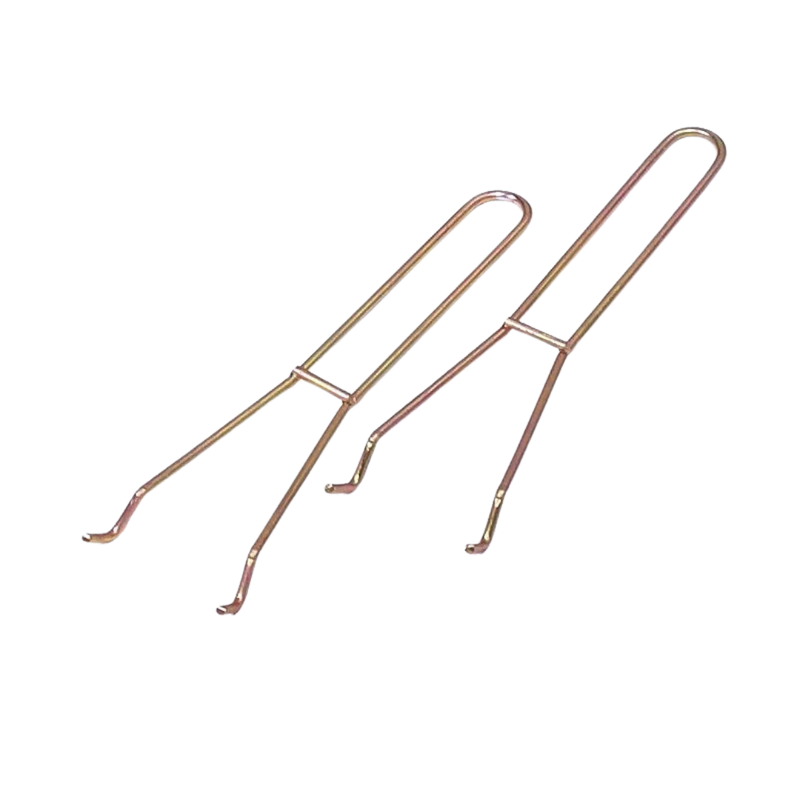 Two gold-colored fireplace grid lifters with handles, isolated on a white background.