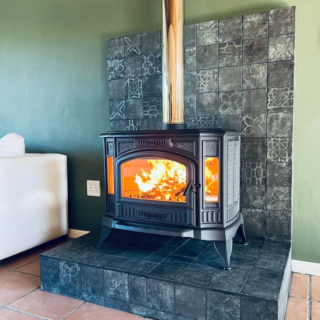 Kratki K9 cast iron wood stove shown in a cozy living room setting