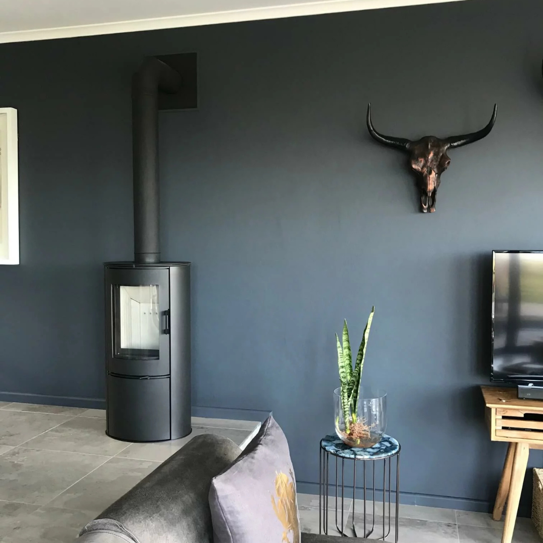 Kratki ABS freestanding stove in a styled room, efficient wood heater.