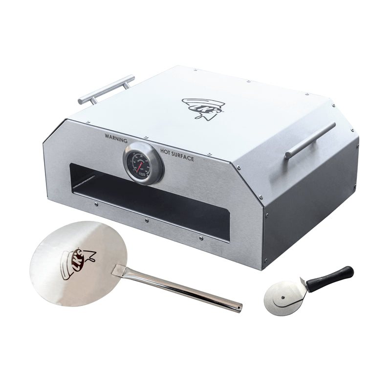 A silver stainless steel pizza oven with a thermometer and two handles, accompanied by a pizza peel and a brush.