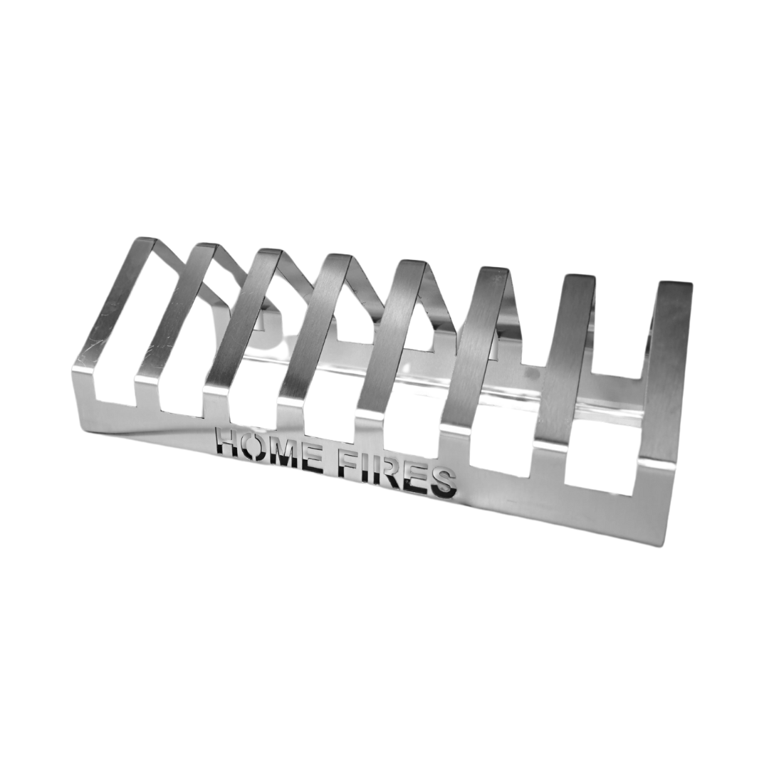 A silver T-Bone grill rack with the text 'HOME FIRES' inscribed on the side.