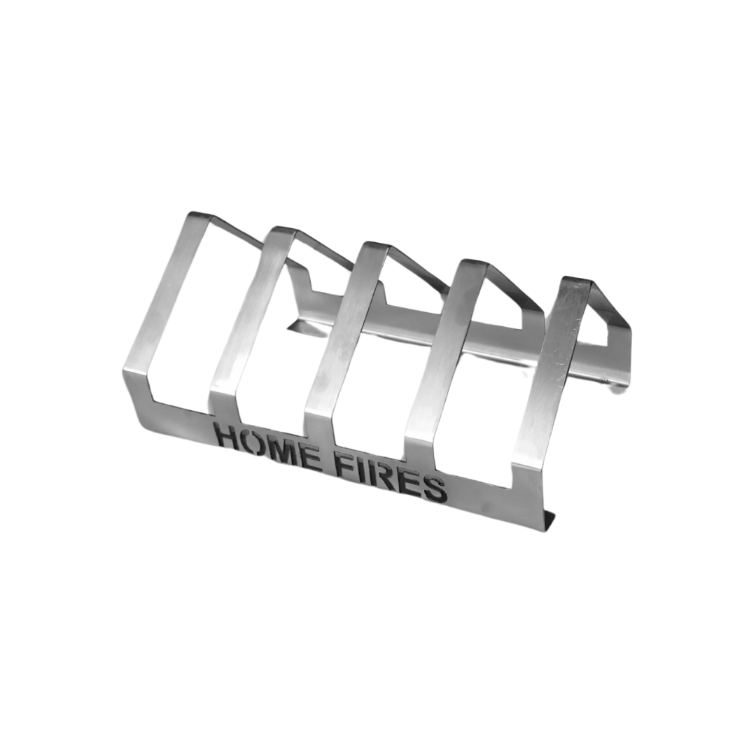 A silver T-Bone grill rack with the text 'HOME FIRES' inscribed on the side.