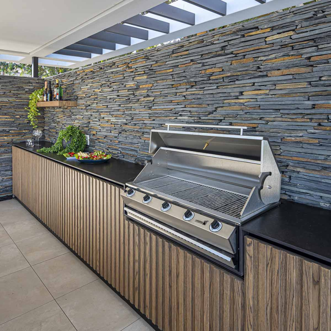 Sizzler gas braai grilling outdoors with food and utensils