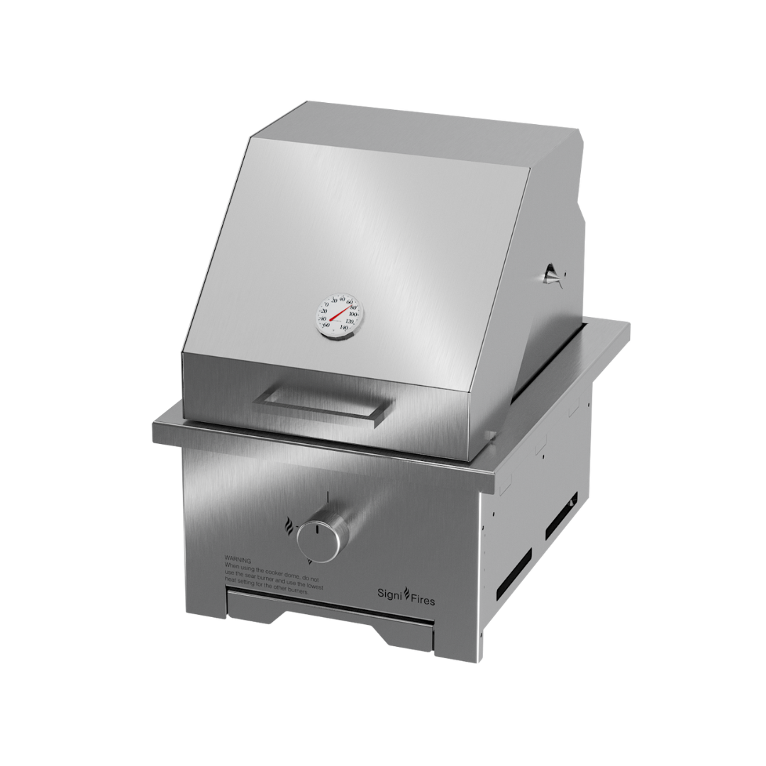 A built-in stainless steel braai (grill) with a closed lid, designed to be inserted into a chimney breast.