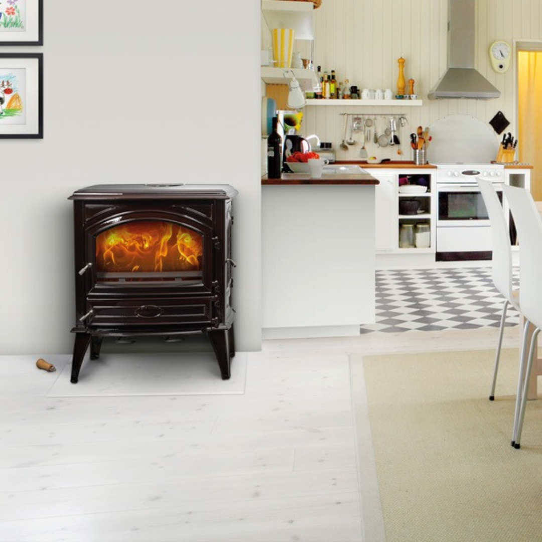 A black freestanding wood-burning fireplace with a side door and visible flames.