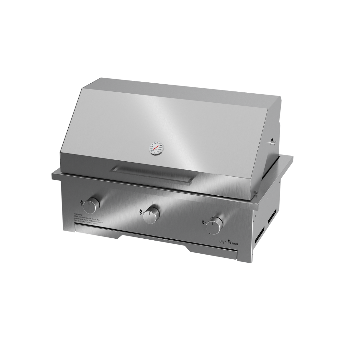 A built-in stainless steel gas braai with a closed sliding door and visible control knobs.