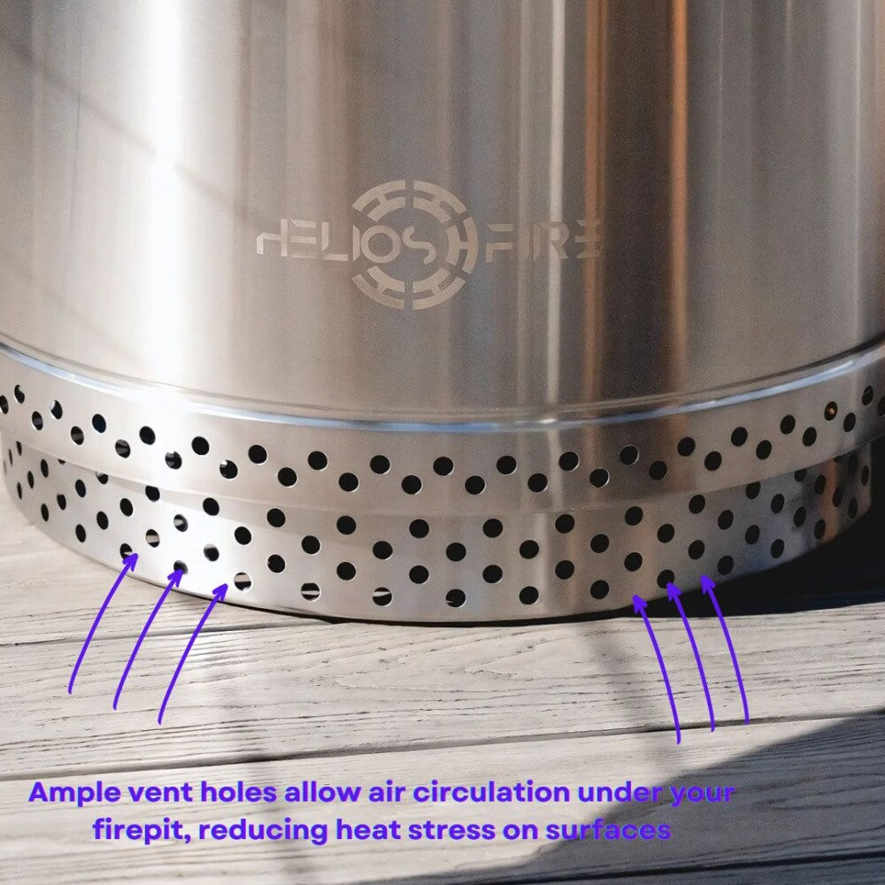 Metal fire pit with Helios Fire branding and vent holes on a wooden surface.