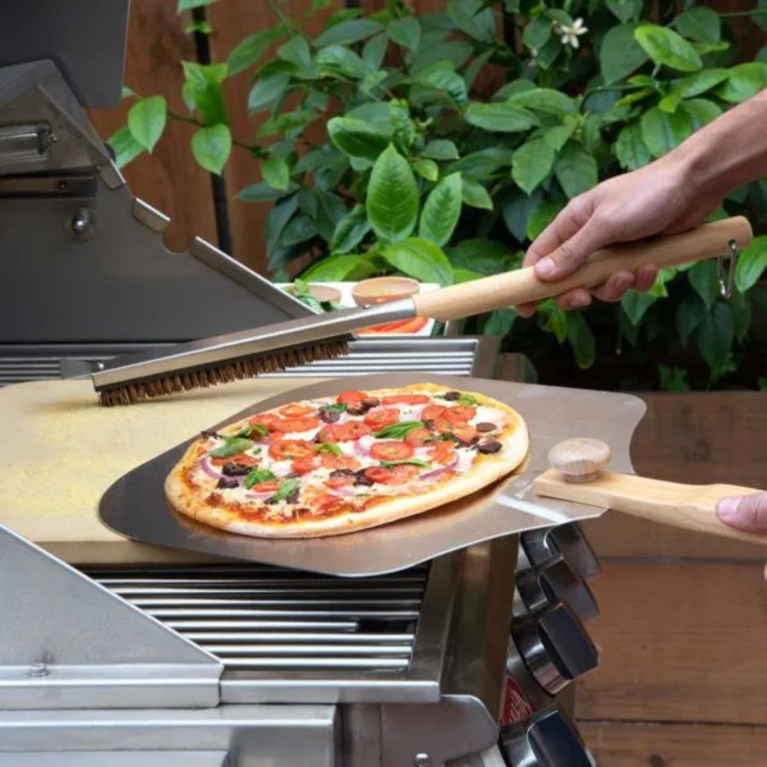 Pizza stone cleaning brush, lifestyle image showing tool that maintains baking stone and pizza oven performance.