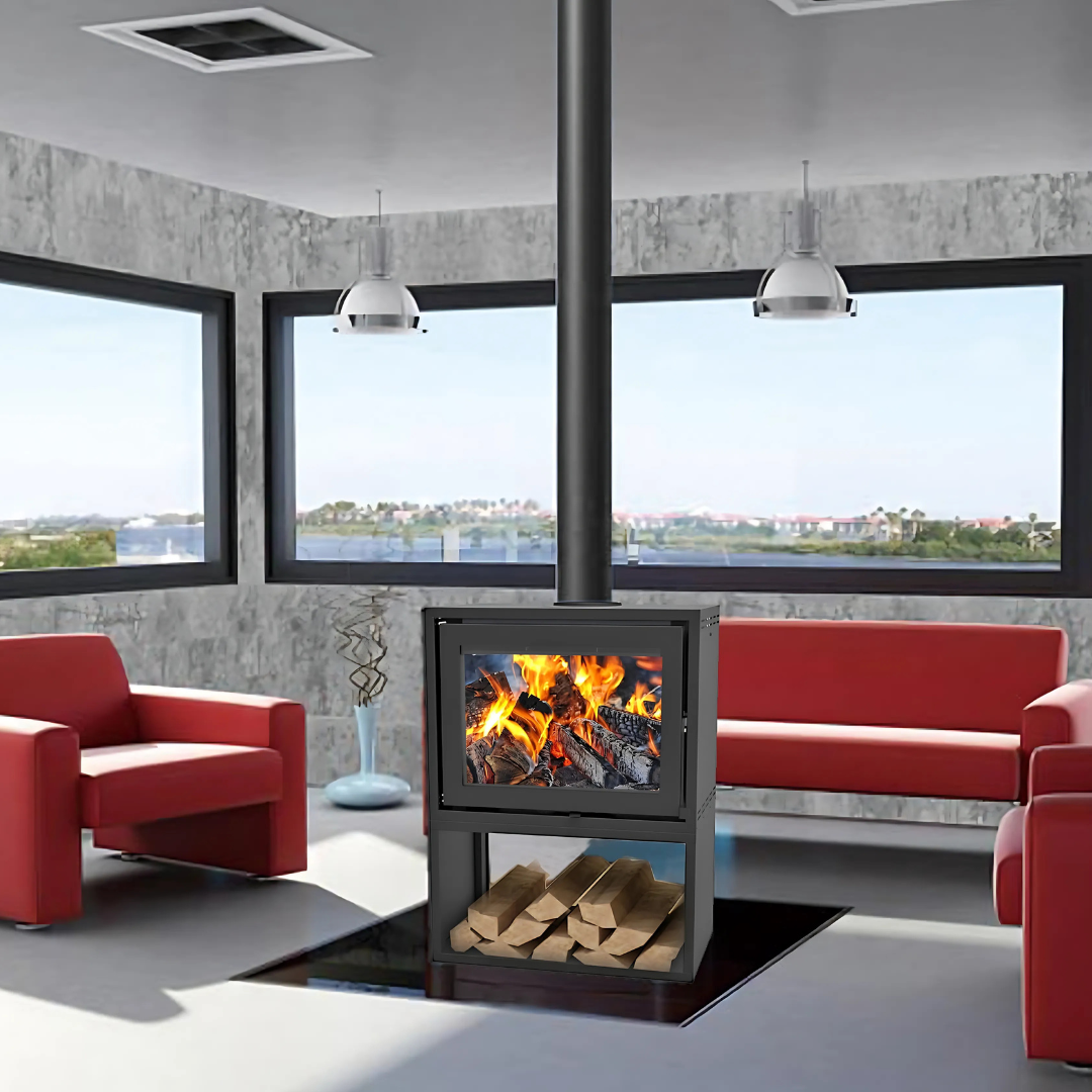 A double-sided freestanding wood stove with a visible fire compartment and log holder, placed in a room with red armchairs and a sofa.