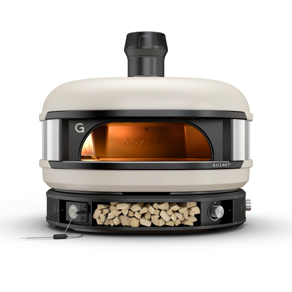 Gozney pizza oven with wood storage on a white background