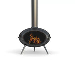Modern black freestanding fireplace with a vertical chimney and a fire burning inside."